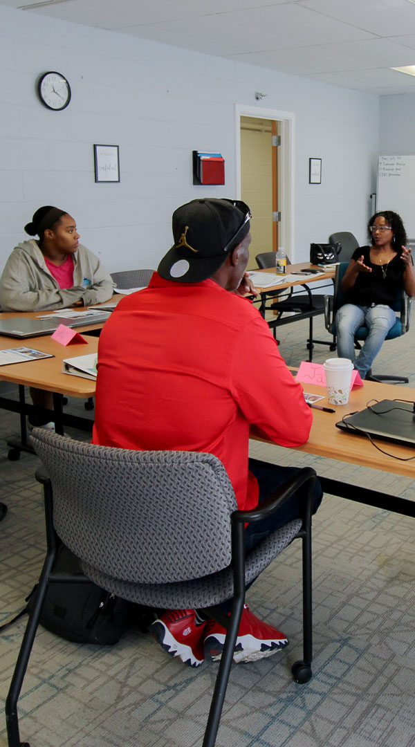 Urban Alliance program participants work with a facilitator in a classroom setting