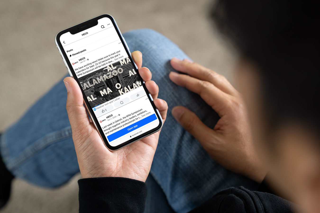 person holding a phone displaying a social post with an imaginative graphic