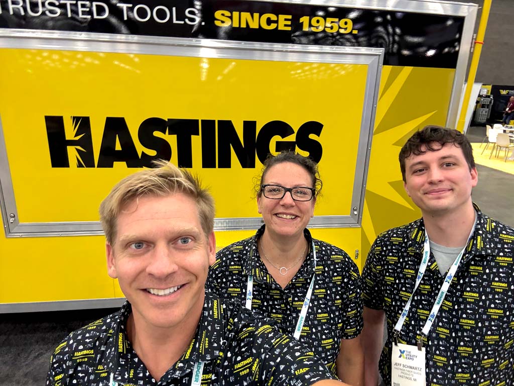 Austin, Jeff, and Martha don Hastings logo wear shirts as they promote Hastings at a trade show while capturing product demo footage.